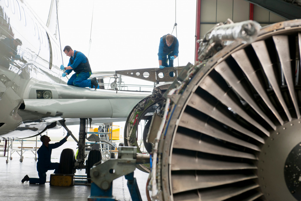 aircraft maintenance crew doing their work on a hangar