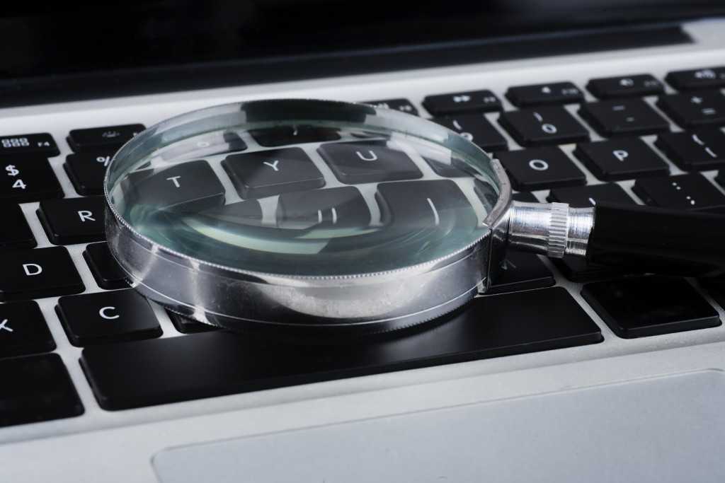 Magnifying glass on laptop keyboard