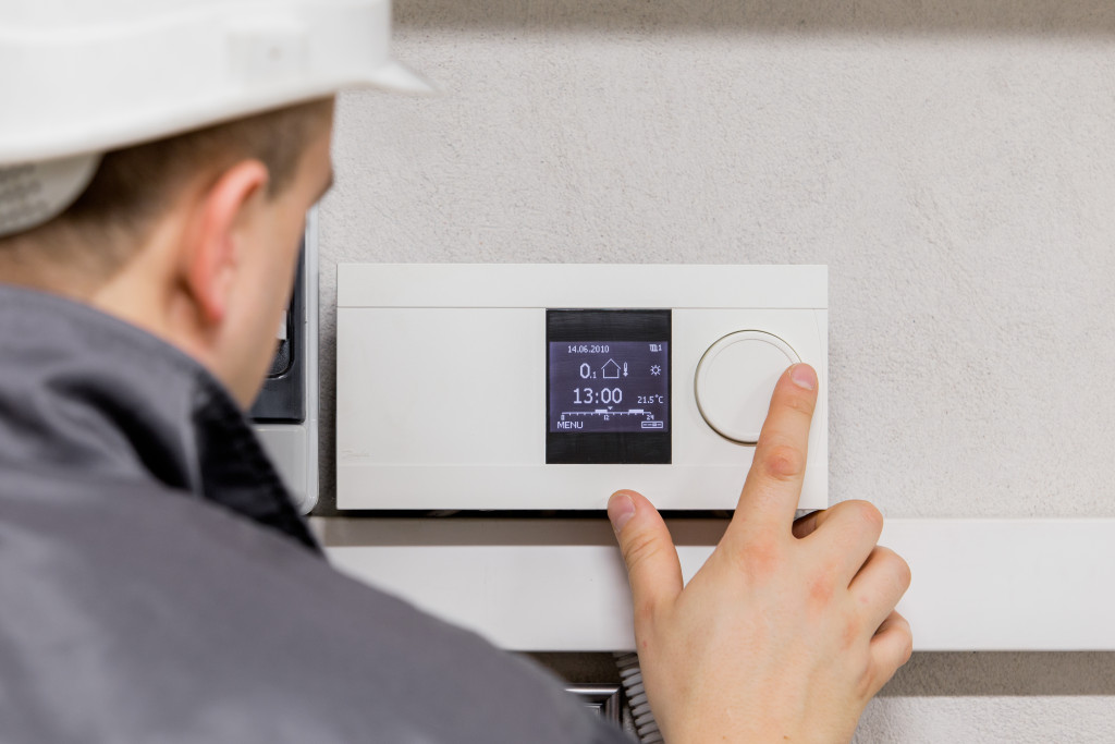 commercial thermostat being controlled by professional man